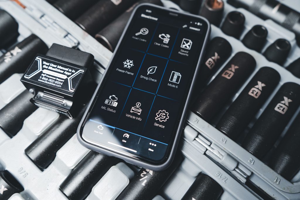 Smartphone affichant application diagnostic OBD2 en garage